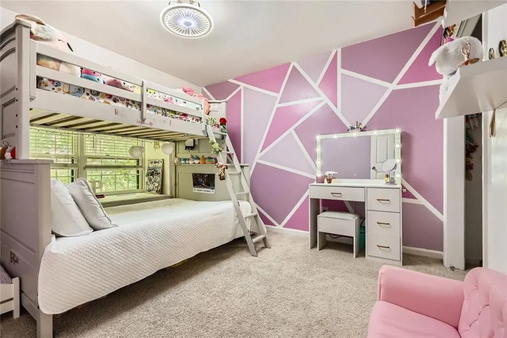 Bedroom featuring light colored carpet and baseboards