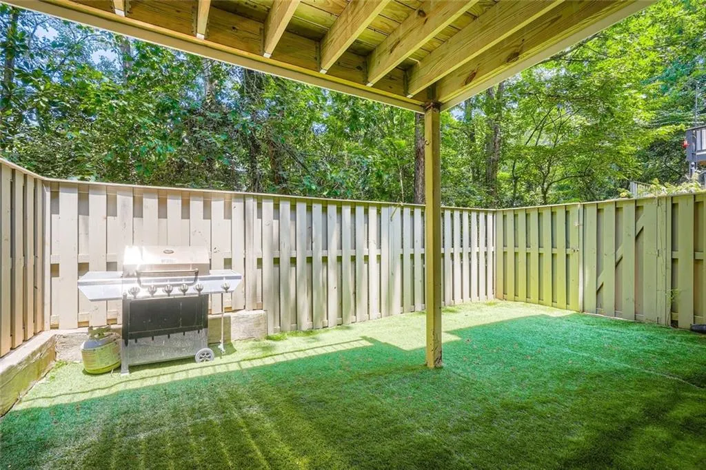 Fenced backyard with a patio area