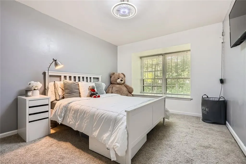 Bedroom with light carpet and baseboards