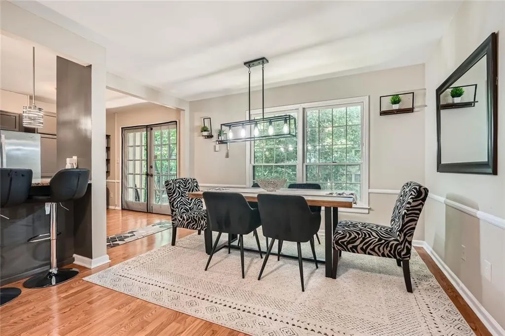Dining space featuring french doors, wood finished floors, plenty of natural light, and a desk