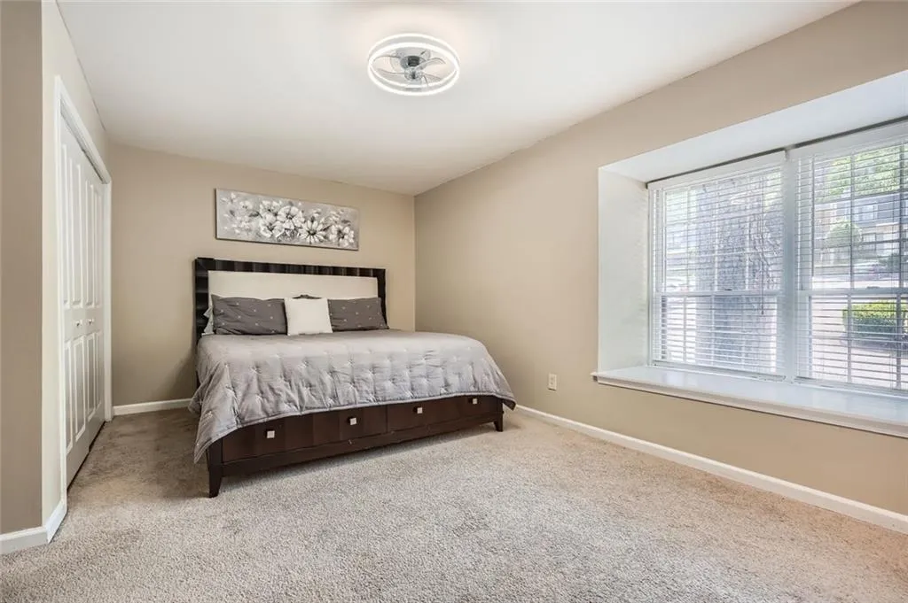 Carpeted bedroom featuring baseboards