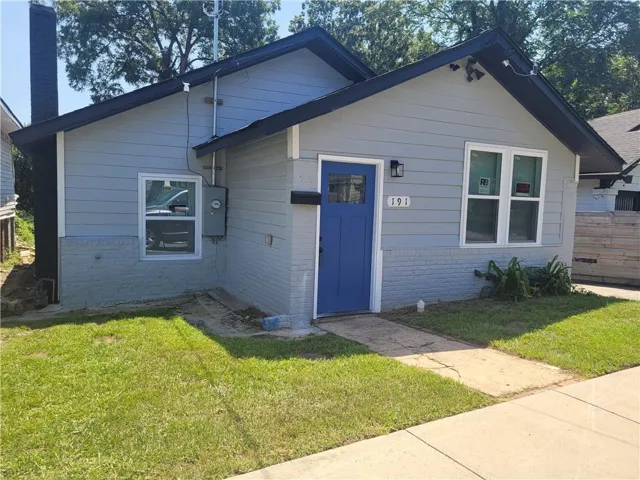 Light blue siding exterior with a contrasting dark blue entry door