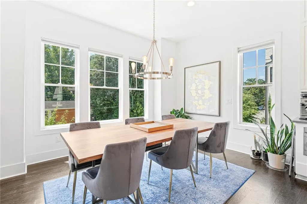 Dining room with dark wood-style flooring, a chandelier, and recessed lighting