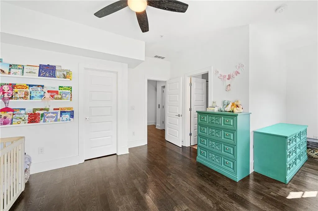 Bedroom with dark wood finished floors and a ceiling fan