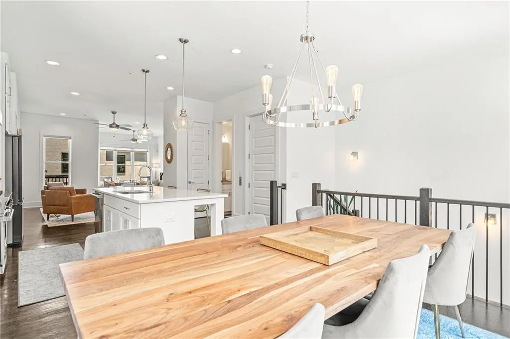 Dining area with dark wood finished floors, recessed lighting, ceiling fan, and a chandelier