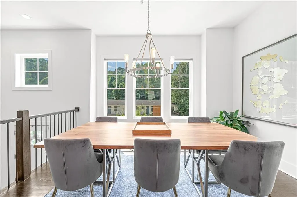 Dining area with wood finished floors and a chandelier