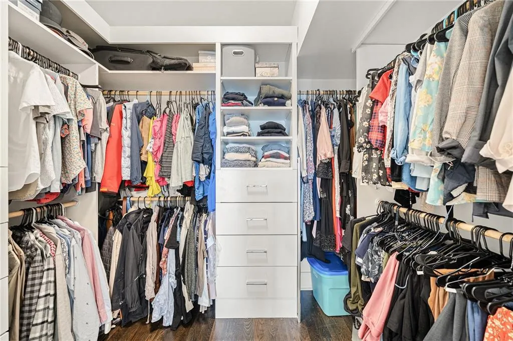 Spacious closet featuring dark wood finished floors