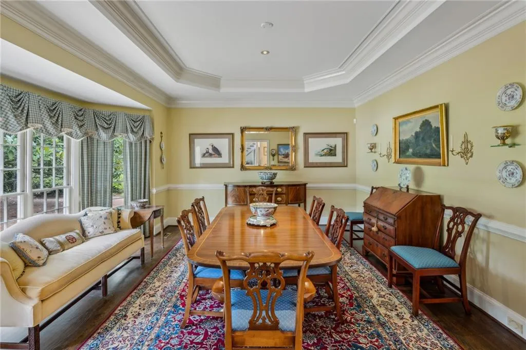Dining room with tray ceiling, chair rail and beautiful bay windows