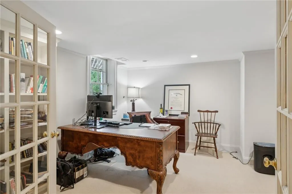Bright, terrace level office with French doors and built-in bookcases