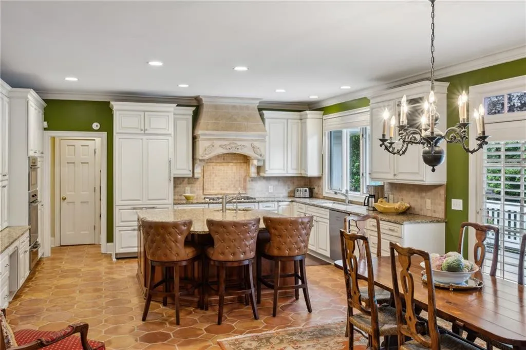 Renovated kitchen with custom cabinetry, Sub-zero refrigerator/freezer, Miele gas cooktop and ovens, new dishwasher, and custom vent hood