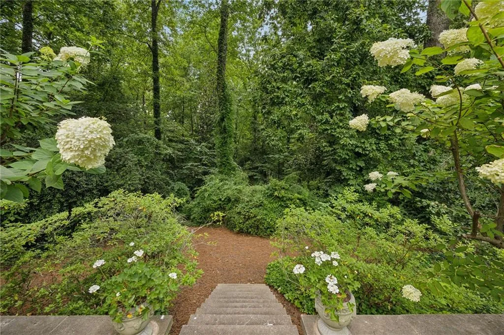 Steps to the rear of the wooded property with its magnificent privacy