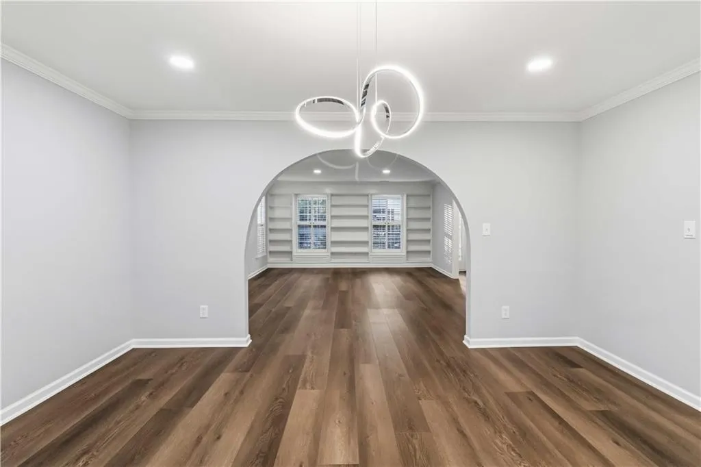 Dining room looking into living room with beautiful custom shelving.