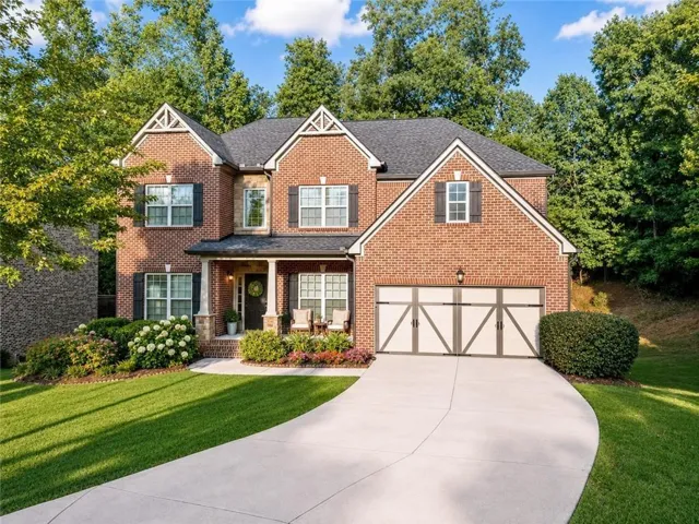 Brick exterior with white window trim and dark shutters