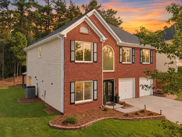 An arched window and a grand front door give this brick beauty its unmistakable smile.