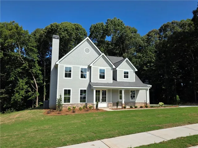 Two-story residence featuring light gray siding, white trim, a covered front porch, and a prominent chimney