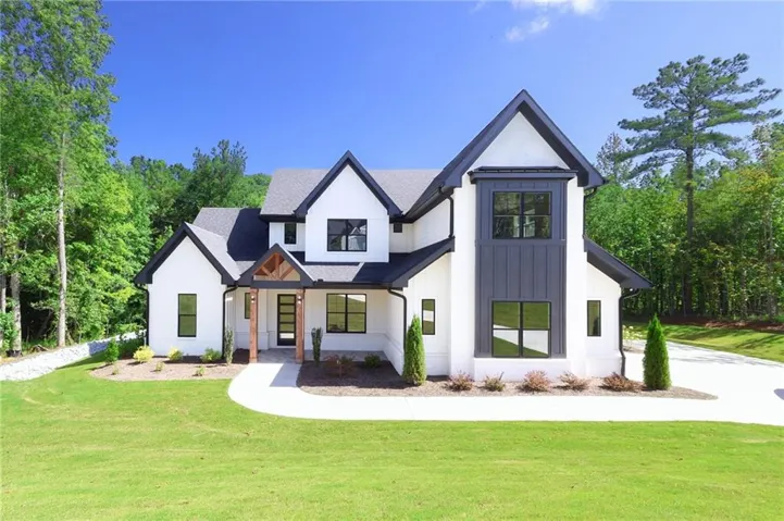 Modern farmhouse-style exterior with white siding and black trim