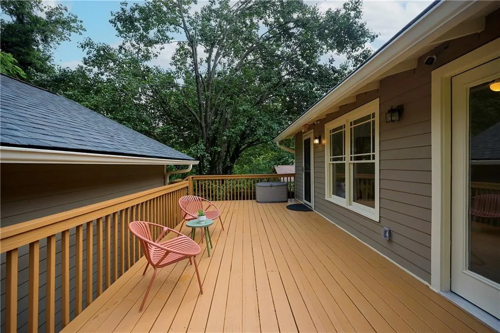 Wooden deck with view of wooded area