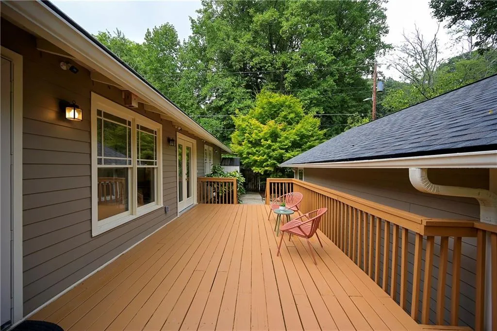 Wooden deck with view of wooded area