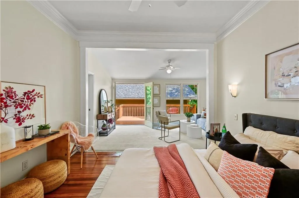 Bedroom with a ceiling fan, wood finished floors, access to outside, and crown molding