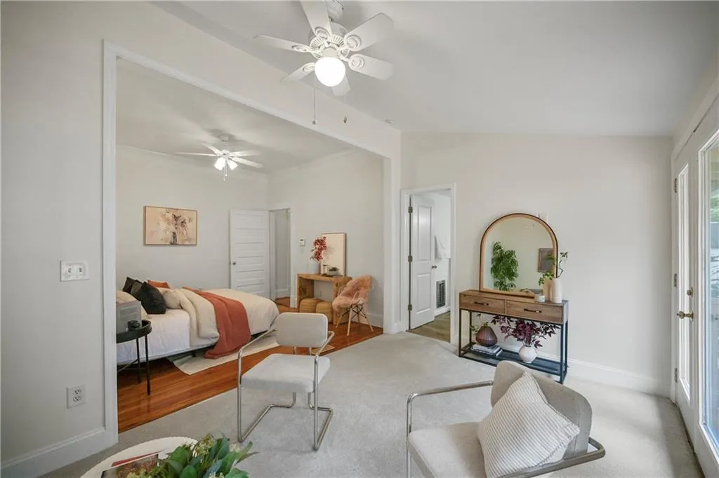 Bedroom with a ceiling fan, lofted ceiling, and carpet flooring