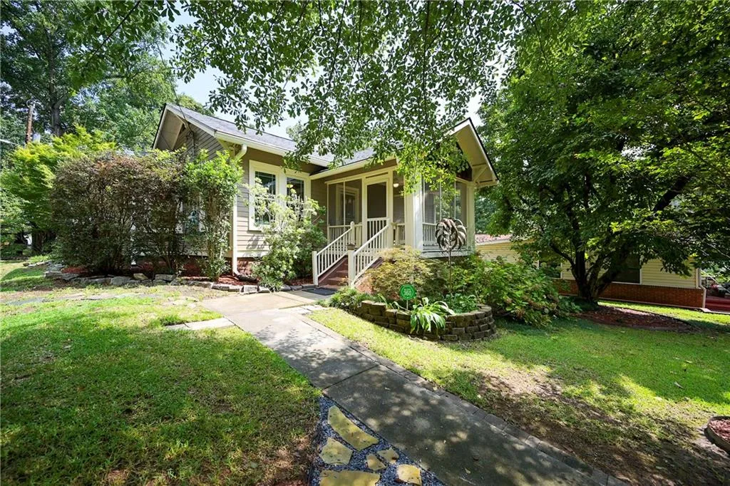 View of front of property with a porch and a front lawn