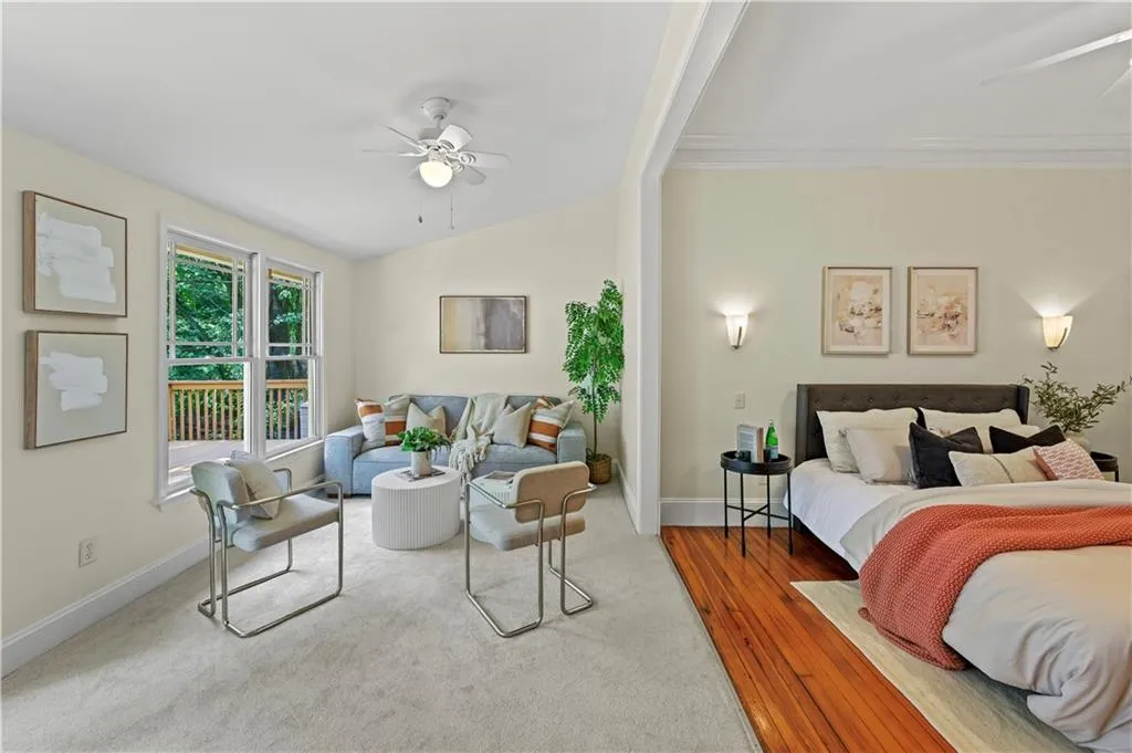 Bedroom featuring ceiling fan, lofted ceiling, carpet floors, and wood finished floors