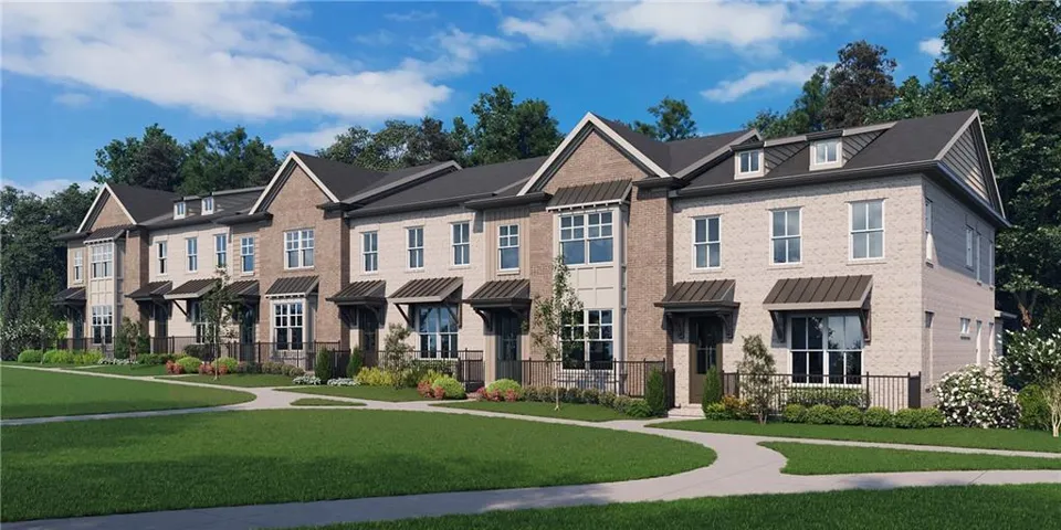 Row of townhomes featuring brick and siding exteriors, dormer windows, metal awnings, and manicured landscaping