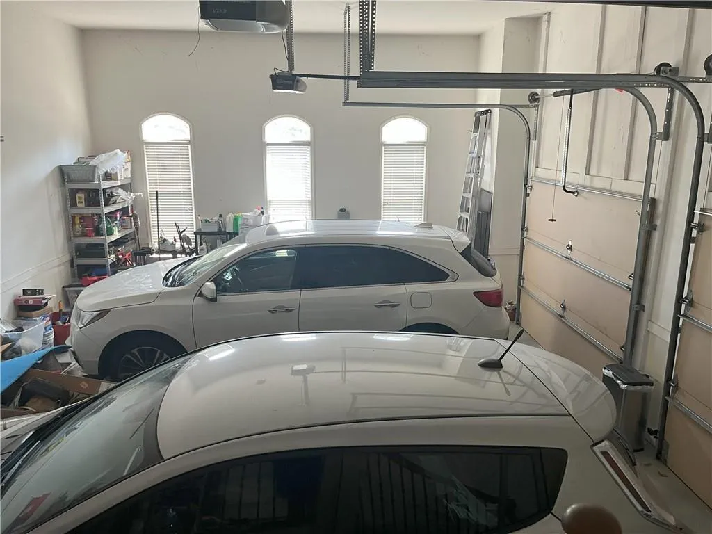 Garage featuring a garage door opener