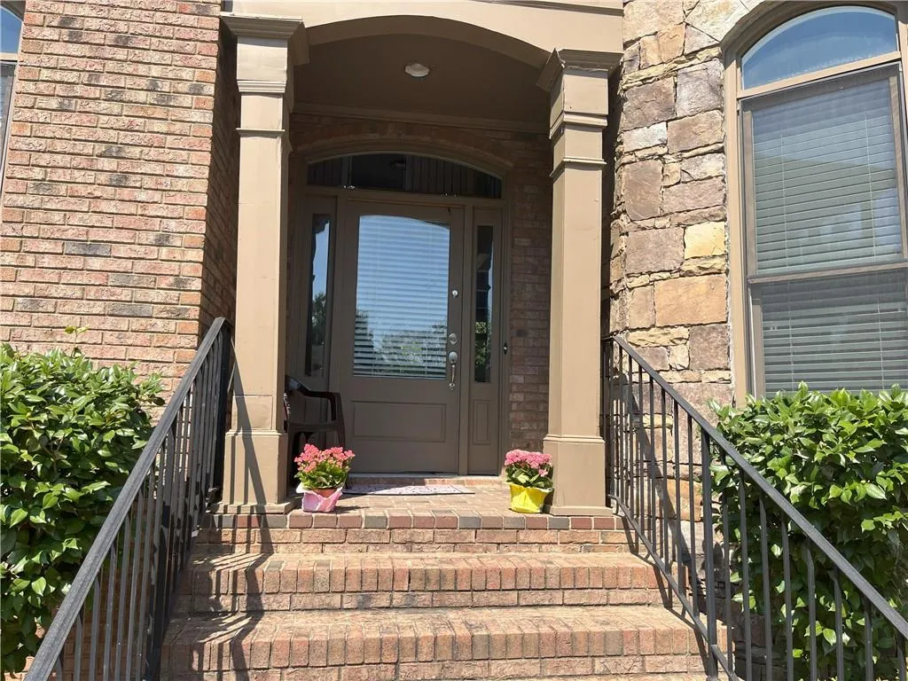 View of exterior entry featuring brick siding