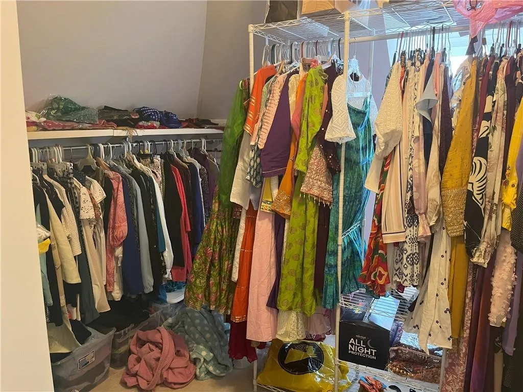 Spacious closet with carpet flooring