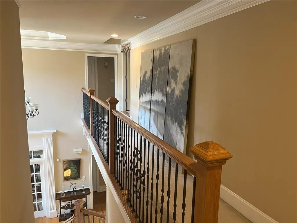 Stairway featuring crown molding, a chandelier, and recessed lighting