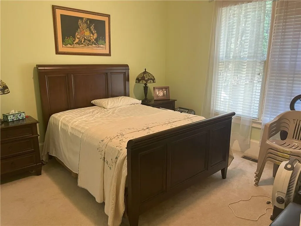 Bedroom featuring light colored carpet