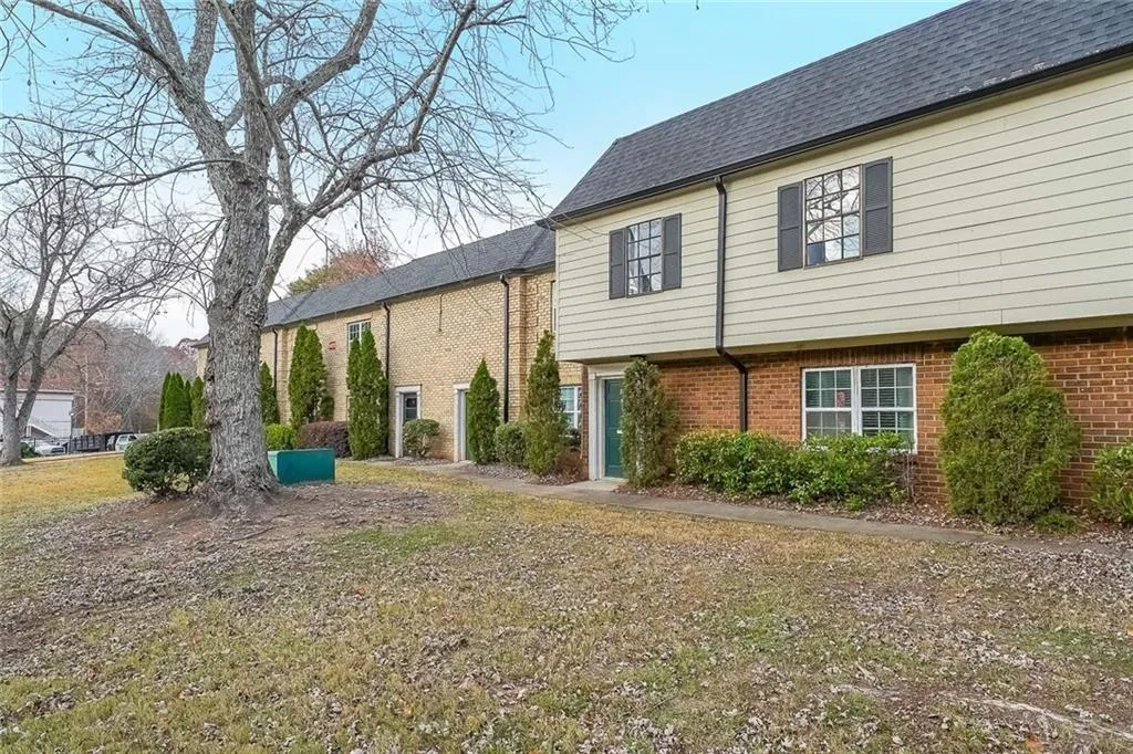 Rear view of property featuring brick siding