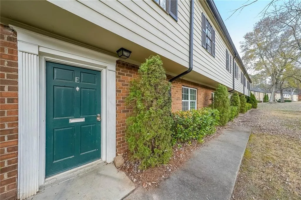 Property entrance featuring brick siding