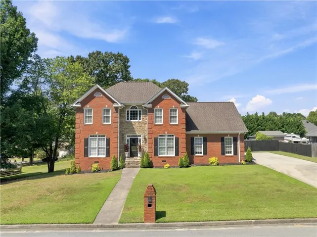 Brick and stone facade residence with a gabled roofline