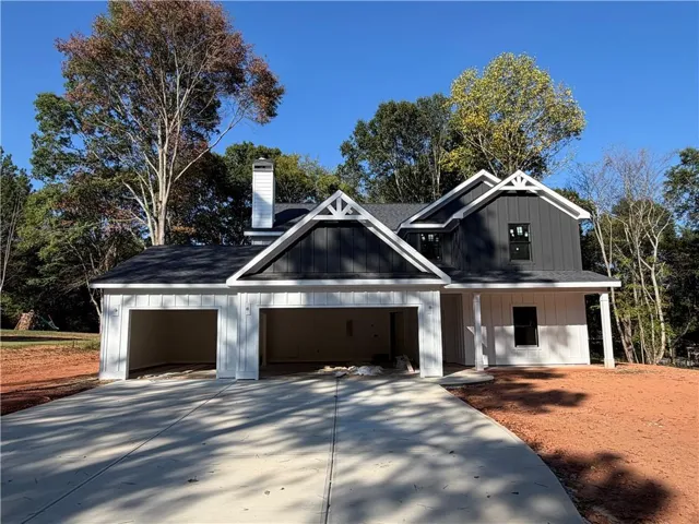 Modern farmhouse exterior with dark and light vertical siding