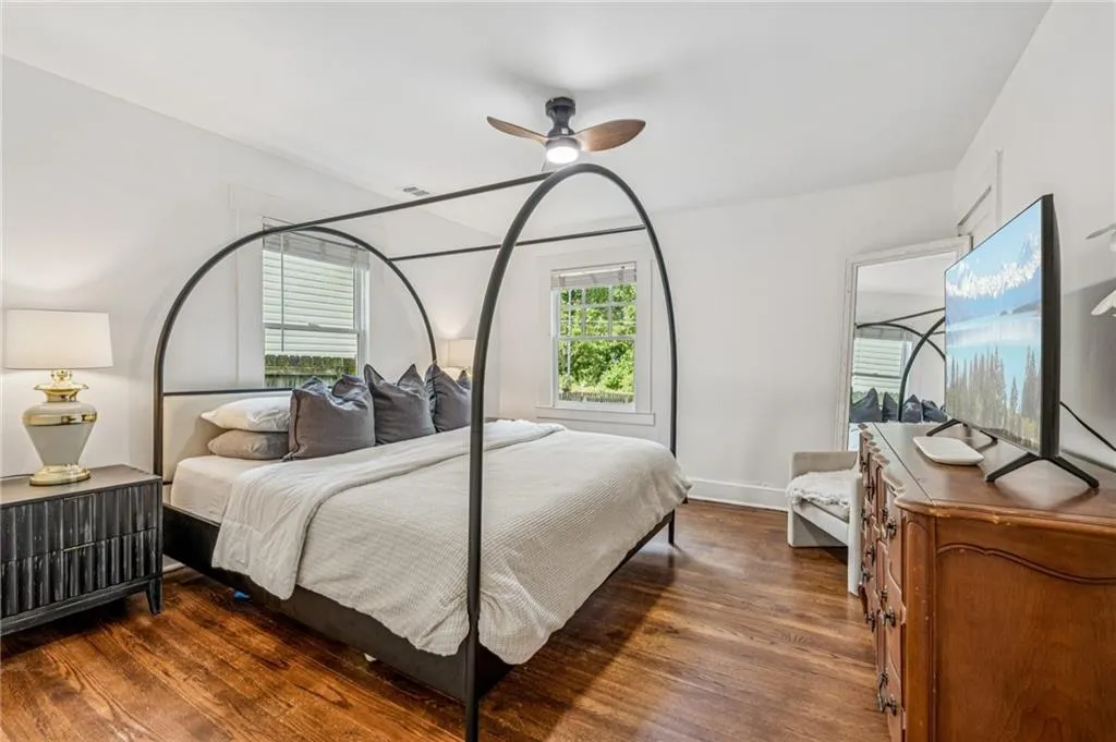 Bedroom featuring ceiling fan and dark wood finished floors