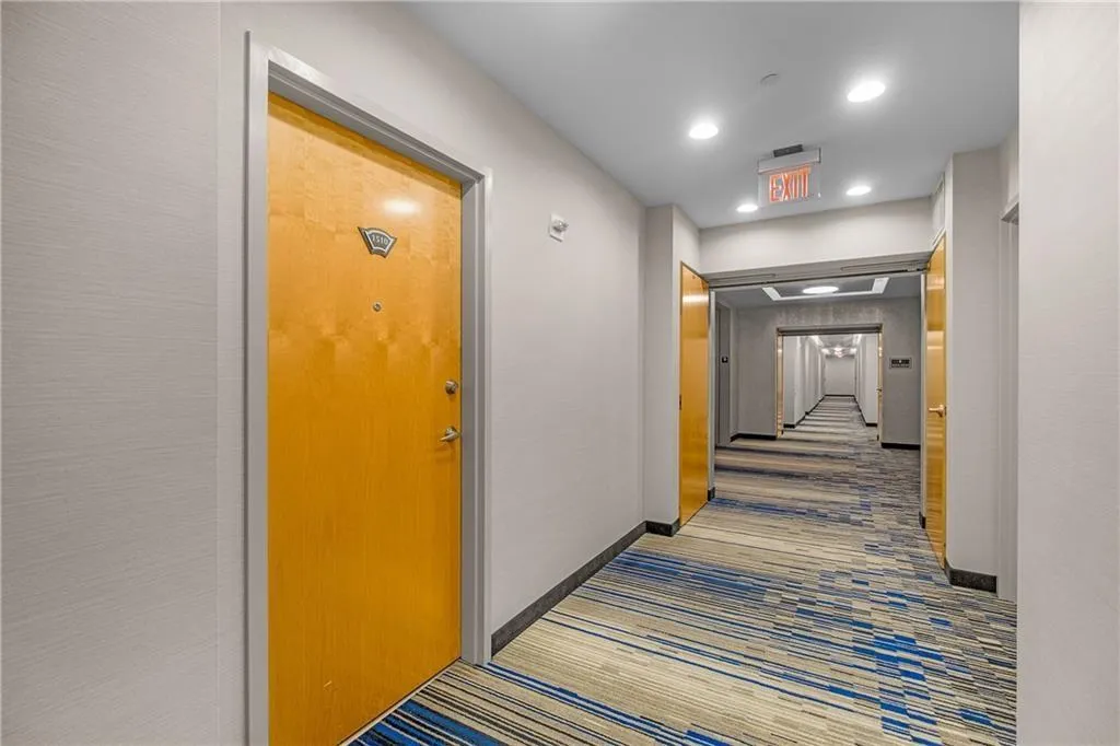 Corridor featuring recessed lighting and baseboards