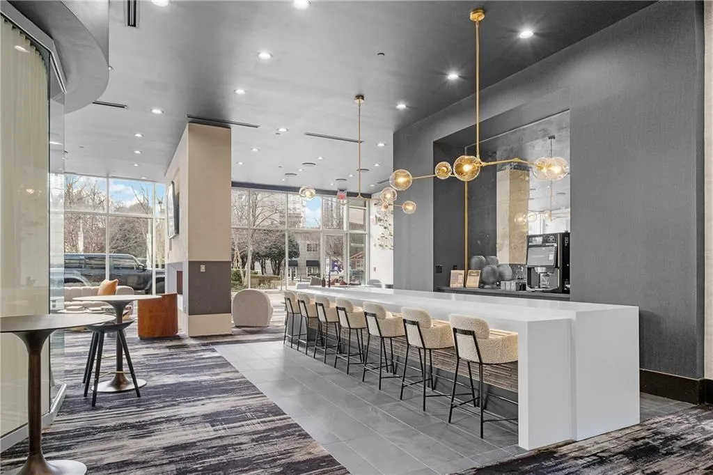 Bar featuring recessed lighting and a high ceiling