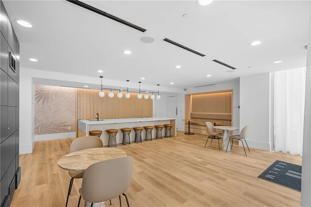 Recreation room featuring light wood-style flooring, recessed lighting, and visible vents