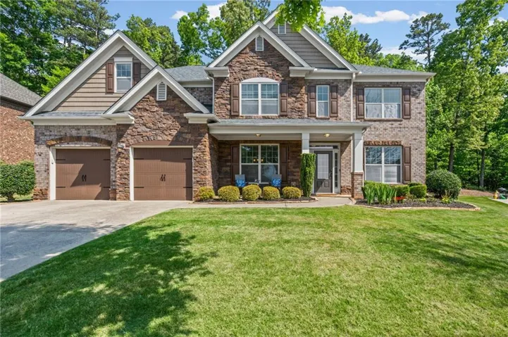 Traditional-style home featuring a stone and brick facade with shake siding accents