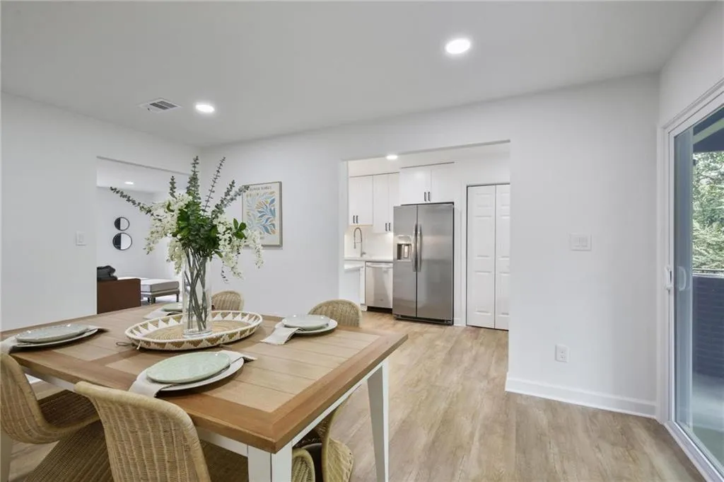 Dining room featuring sink and light wood-type flooring
