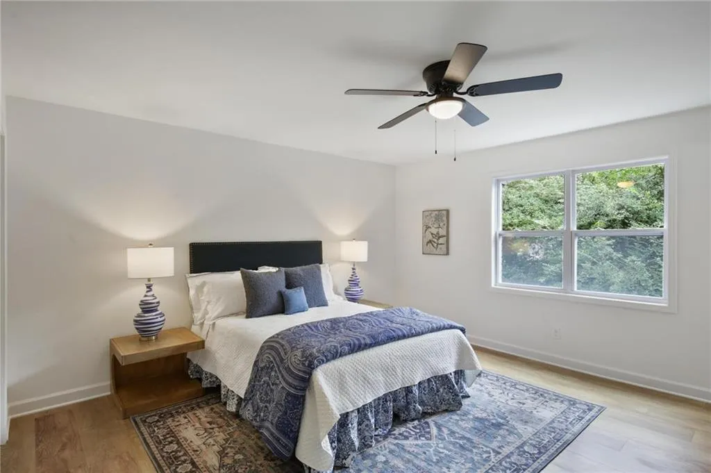 Bedroom with light hardwood / wood-style floors and ceiling fan