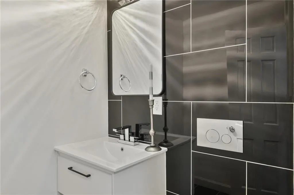 Bathroom featuring vanity and tile walls