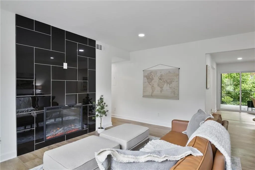 Living room featuring a tile fireplace and light wood-type flooring