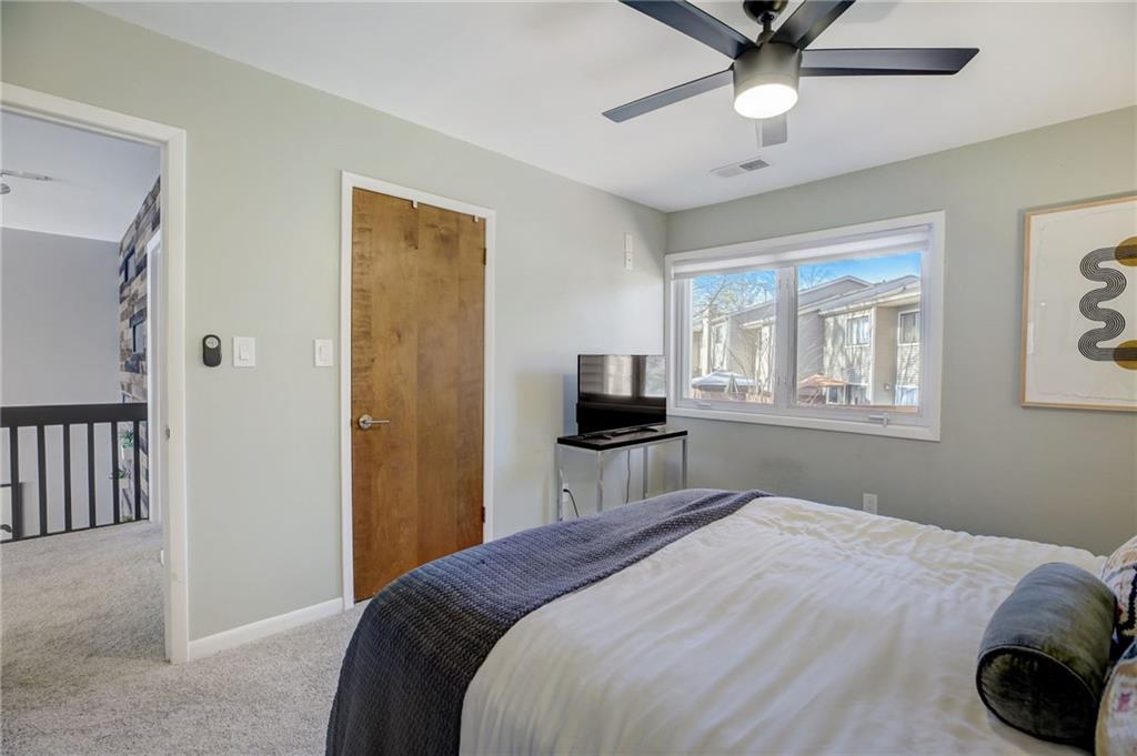 Bedroom featuring a closet, ceiling fan, and light carpet