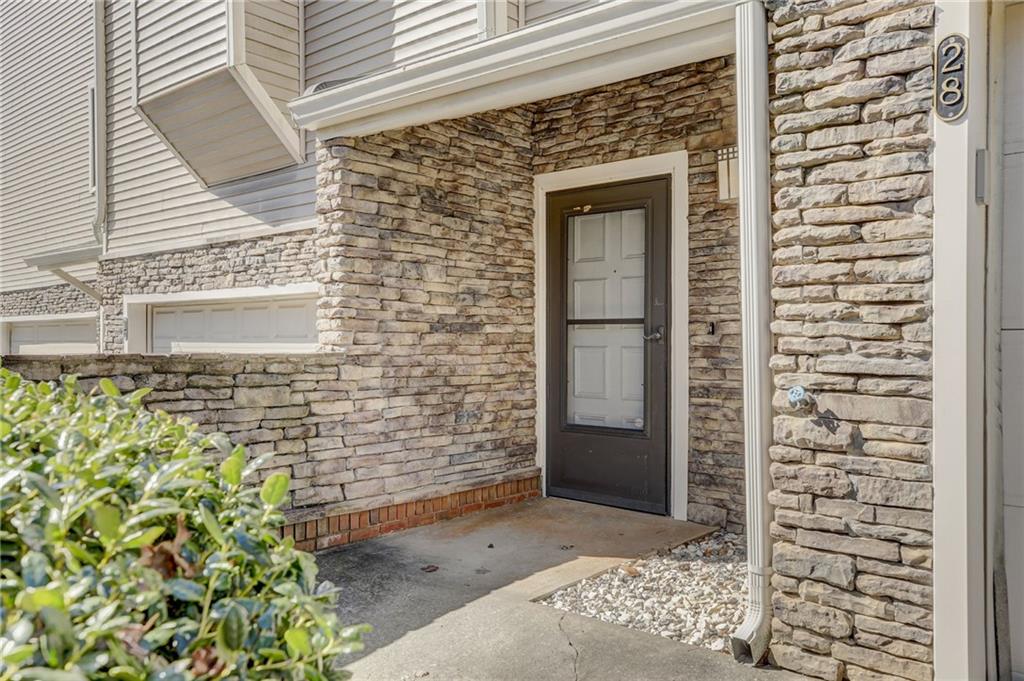 Doorway to property featuring a garage