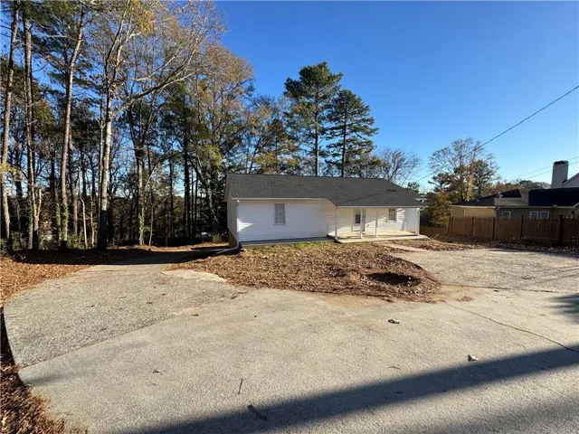 View of front of home with a patio and driveway