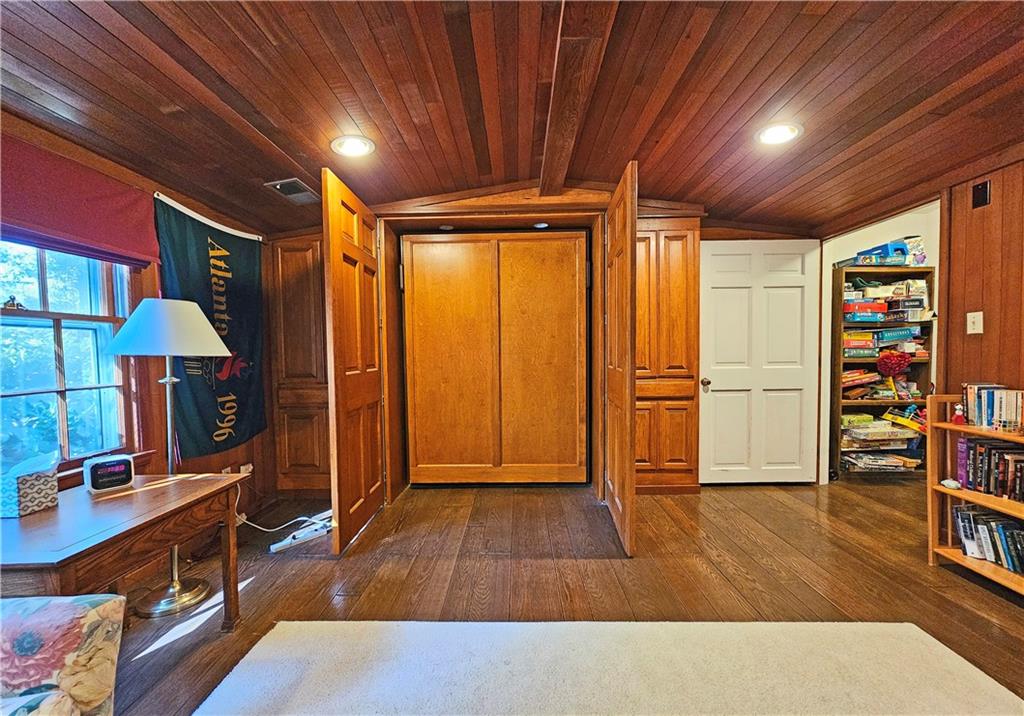 Foyer entrance with wood ceiling, dark hardwood / wood-style flooring, and vaulted ceiling
