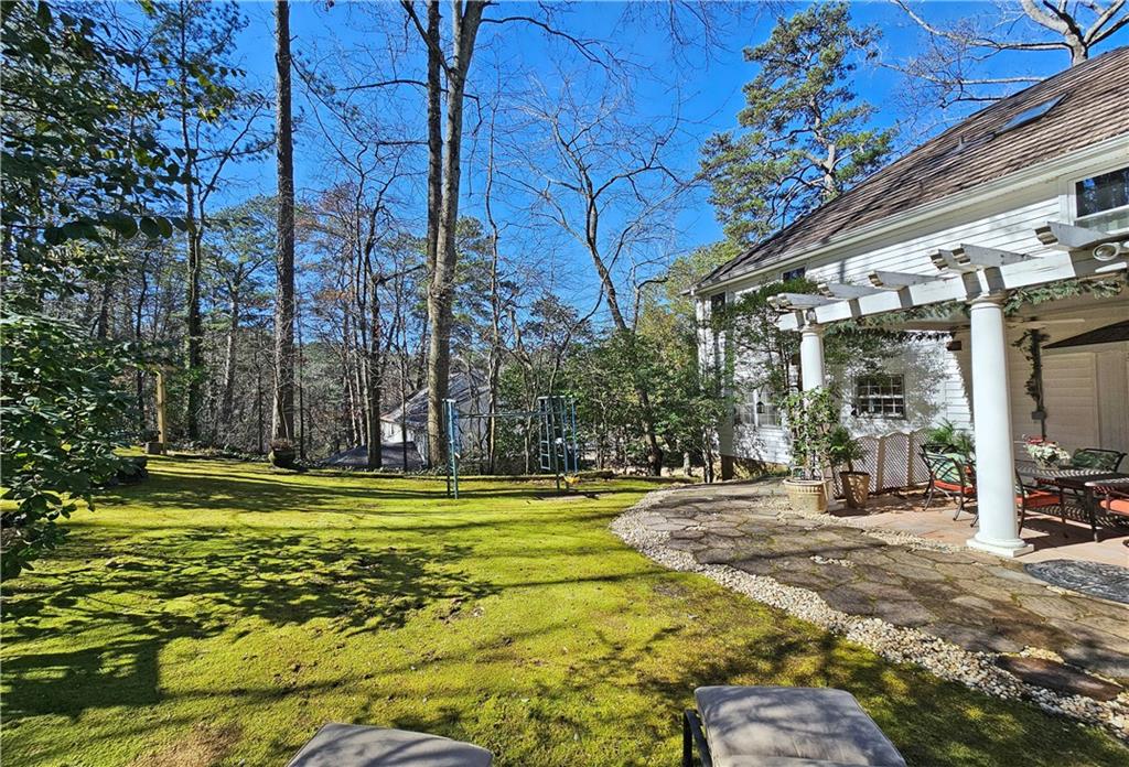 View of yard featuring a pergola and a patio